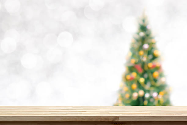 istock Wood table top on blur Christmas tree background 623606400