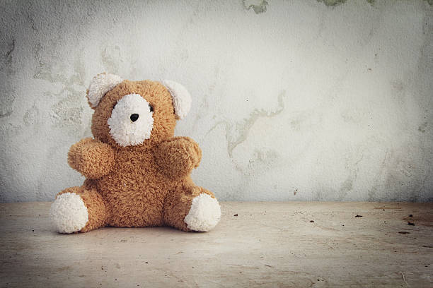istock Retro Teddy Bear toy alone on wooden floor 623608006