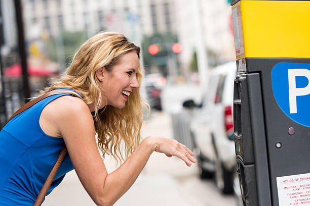 istock Mature caucasian blond woman paying for parking 623608128