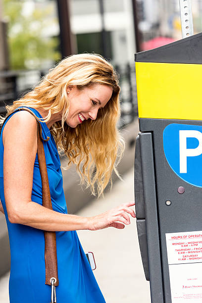 istock Mature caucasian blond woman paying for parking 623608318