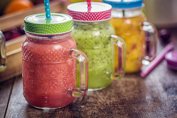 Freshly blended fruit smoothies of various colors and tastes