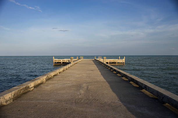 istock cement Bridge to the sea at sunset light 623612386
