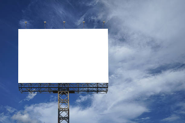 istock Blank big billboard against blue sky background 623612518