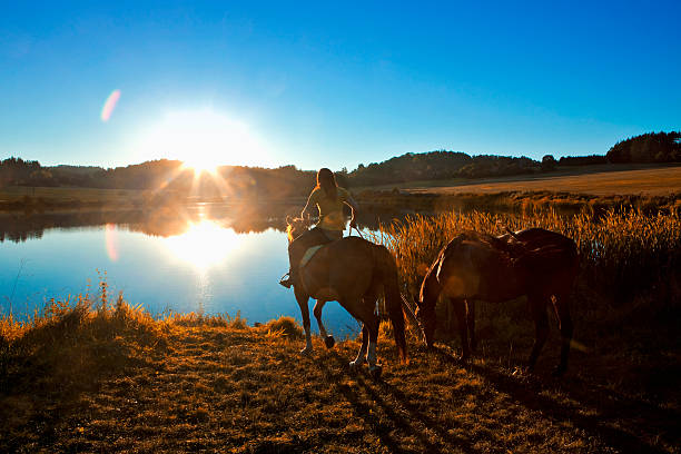 Couple Watering Horses at Creek
