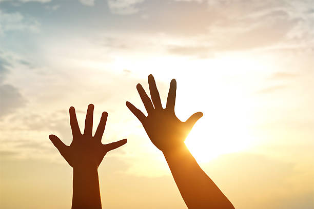 istock silhouette hands mother and son on sunset background 623615356