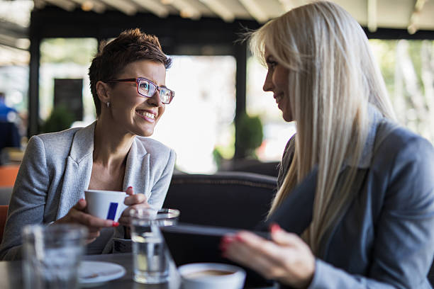 istock Two smiling businesswomen enjoying in a cafe and talking. 623618062