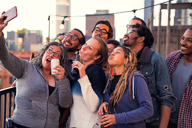 istock Group of friends at a rooftop party taking a selife 623620426