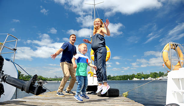 istock mother, father and son playing on the dock. 623620518