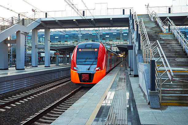 istock Beautiful railway station with modern red commuter train . 623621582