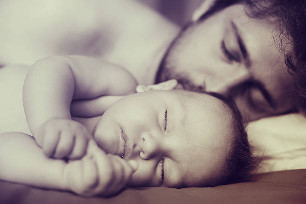 istock father and newborn son sweet sleep. 623621768