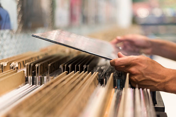 istock Close-up on hands man browsing vinyl album in record store 623622128
