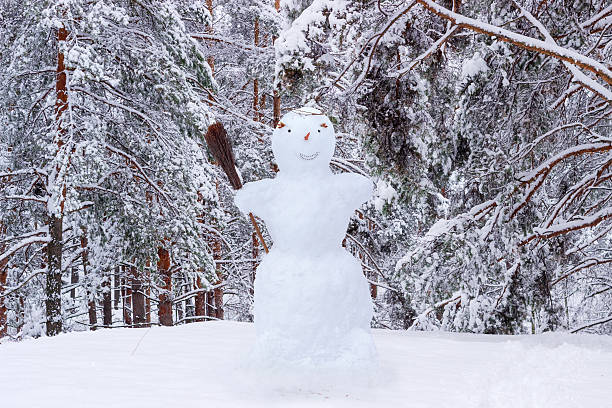 istock Snowman on the background of snow-covered pine forest 623622214