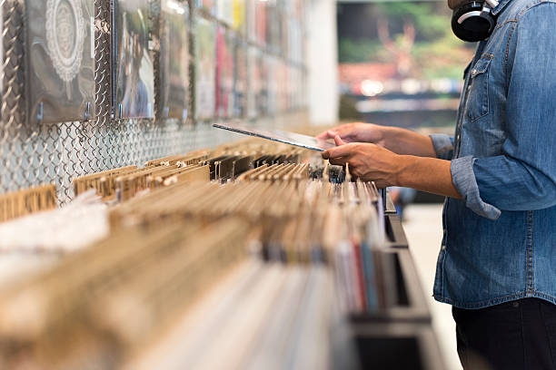 Man browsing vinyl album in a record store stock photo