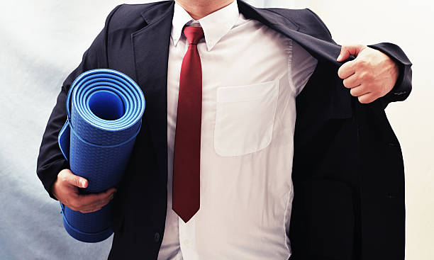 istock business man hold exercise yoga mat 623664444