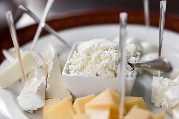 Set of different cheeses, brie cheese, mozzarella and feta cheese on plate