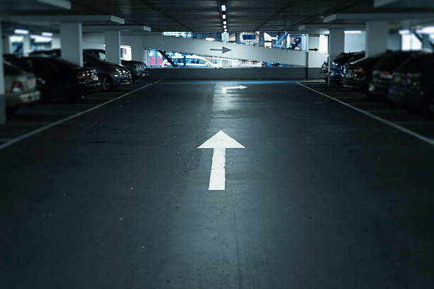 istock Arrow sign on driving lane in parking garage. 623667244
