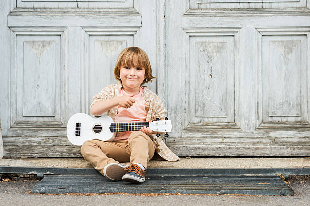 istock Little happy boy plays his guitar 623673746