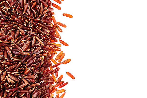 Red rice close-up border on white background. Border of red rice close-up  on white background. Isolated. Decorative frame of wild brown unpolished rice. genmai stock pictures, royalty-free photos & images