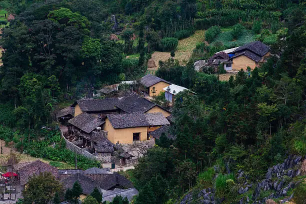 Idyllic beauty of ancient stone houses with stone fence, the road leading to the house was turned from a rural road with porch roofs, wood columns. This is the rustic character of the house in Ha Giang, Vietnam