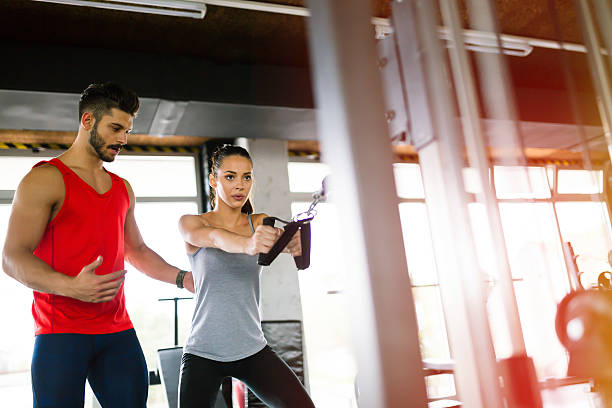 istock Personal trainer giving instructions in gym 623680236