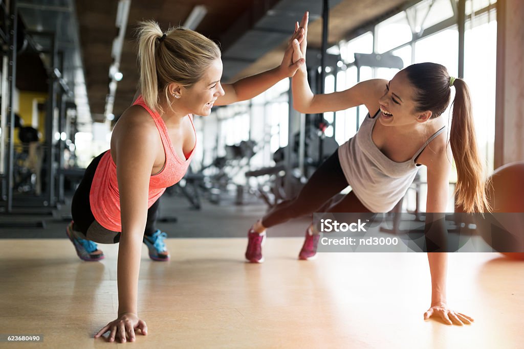 Beautiful women working out in gym Beautiful women working out in gym together Exercising Stock Photo