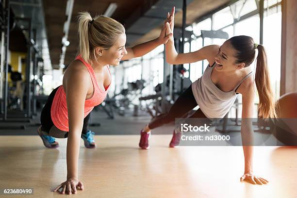 Beautiful Women Working Out In Gym Stock Photo - Download Image Now - Exercising, Gym, Health Club