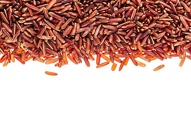 Red rice close-up border on white background. Border of red rice close-up  on white background. Isolated. Decorative frame of wild brown unpolished rice. genmai stock pictures, royalty-free photos & images