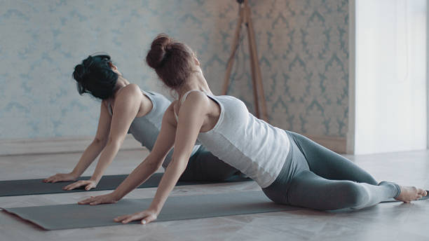 istock Two women doing yoga exercises 623682586