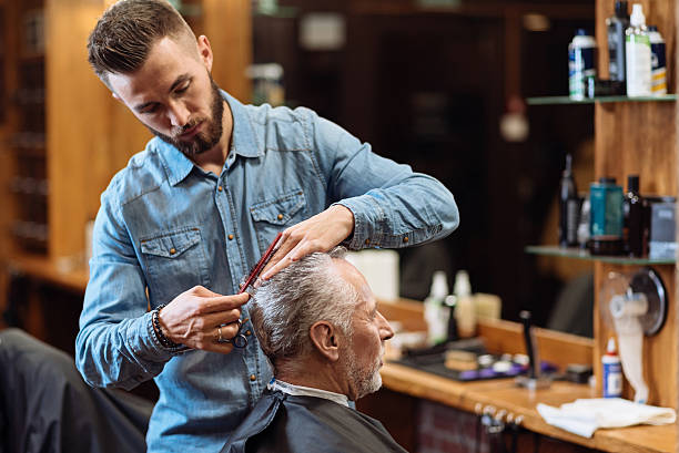 istock Old man having haircut by young specialist 623684176