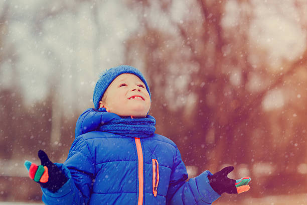 istock little boy enjoy snow in winter nature 623690582