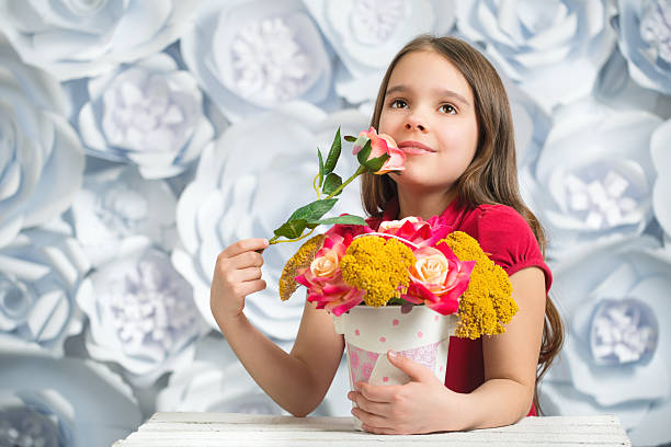 istock Adorable smiling little girl with artificial flower 623691580