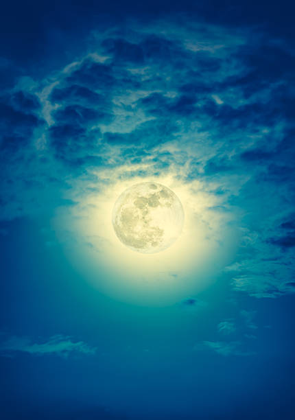 istock Nighttime sky with clouds and bright full moon with shiny. 623692672