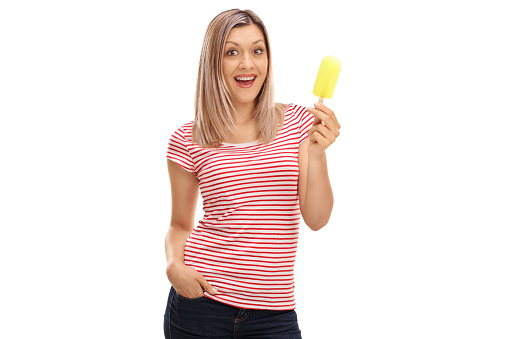 Cheerful woman holding an ice cream isolated on white background