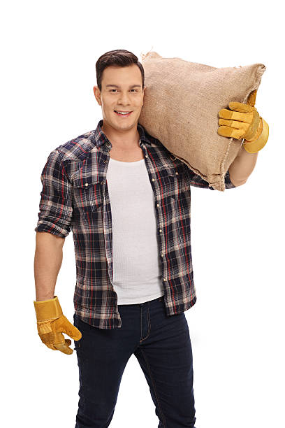 istock Agricultural worker holding a burlap sack on his shoulder 623693686
