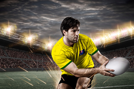 Australian rugby player, wearing a yellow uniform in a stadium.