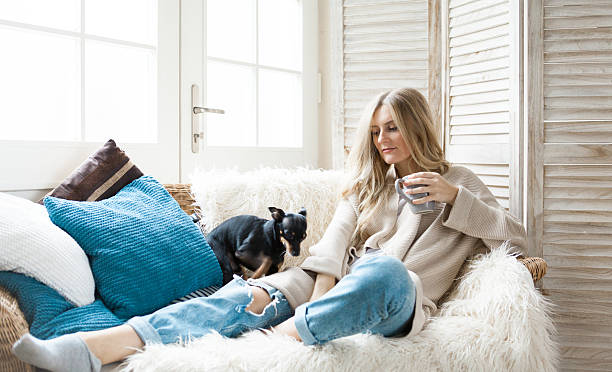 istock Woman on the sofa with her dog 623695216