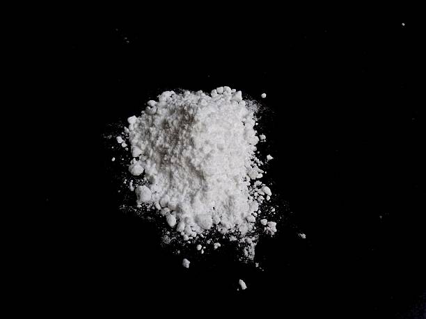 istock Cocaine drug powder pile on black background 623695586