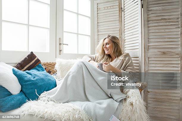 Woman Drinking Tea At Home Stock Photo - Download Image Now - Blanket, Sofa, Women