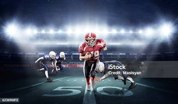 American Football Players In Action On Stadium With Ball Stock Photo - Download Image Now