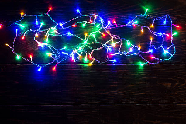 istock Shiny garland border on wooden background 623698470