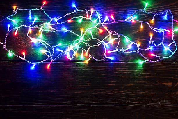 istock Shiny garland border on wooden background 623698654