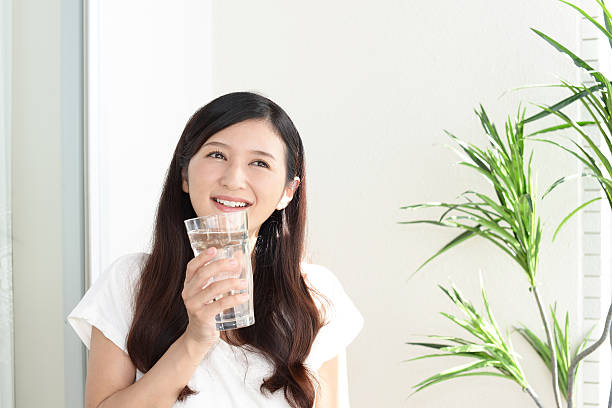 istock Woman drinking a glass of water 623698936