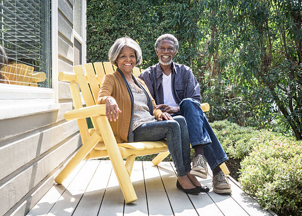 istock Senior African American couple on bench, smiling towards camera 623699364