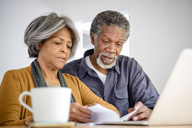 istock Senior couple reading document with laptop 623699456