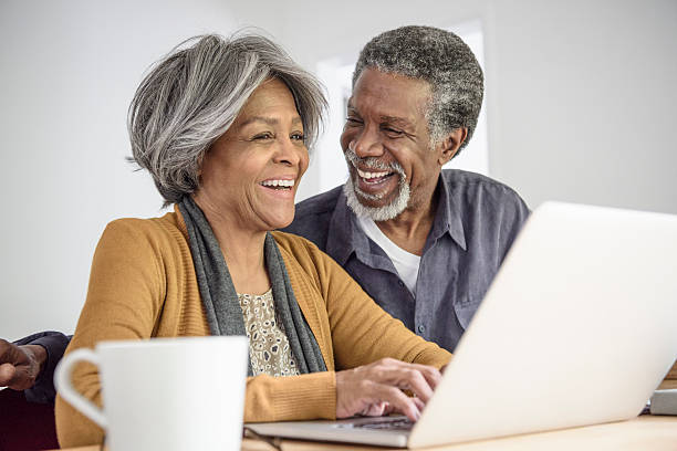 istock Senior African American couple using laptop and laughing 623699534