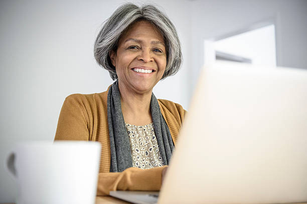 istock Happy Senior African American woman using laptop, smiling 623699566