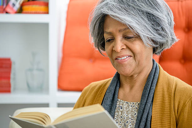 istock Senior African American woman reading a book 623699604