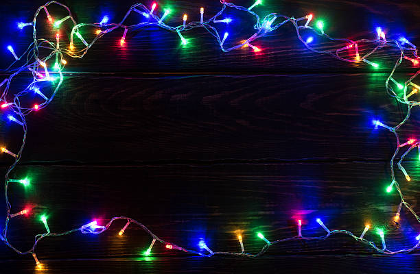 istock Shiny garland border on wooden background 623699696