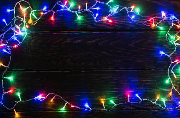 istock Shiny garland border on wooden background 623699912
