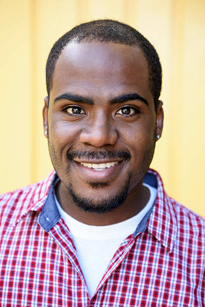 istock Young African American man smiling in checked shirt 623699932